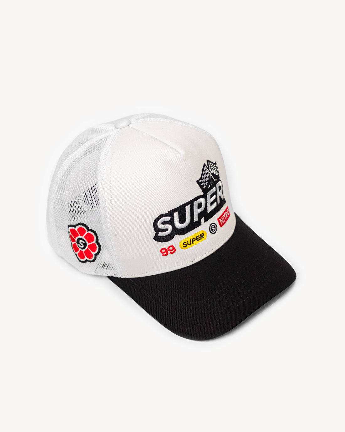 Side view of a fresh two-toned white and black snapback hat showcasing side patch design of flower, with designer racing-inspired patches on the front and a cooling mesh rear design.
