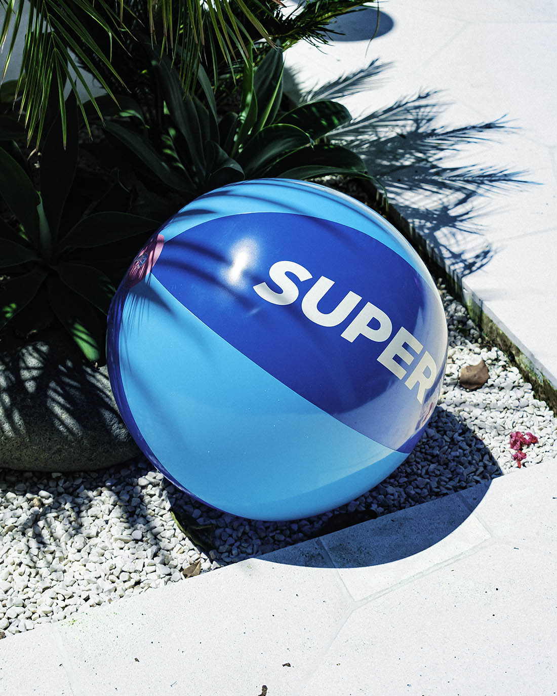 Solid blue beach ball with 'SUPER' text, perfect for summer fun by the pool or beach, compact design.