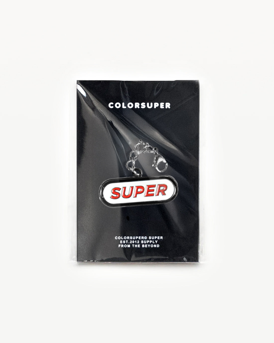 Colorsuper SUPER charm in packaging, featuring bold logo design and durable clip for classic style.