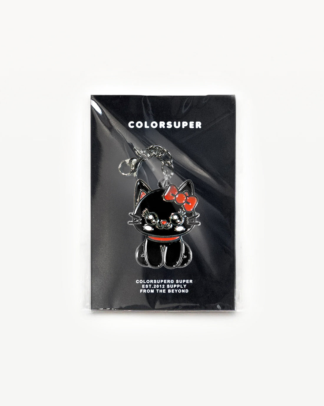 Cute black cat charm with red bow in packaging, radiating cool-cat vibes and sparkle.