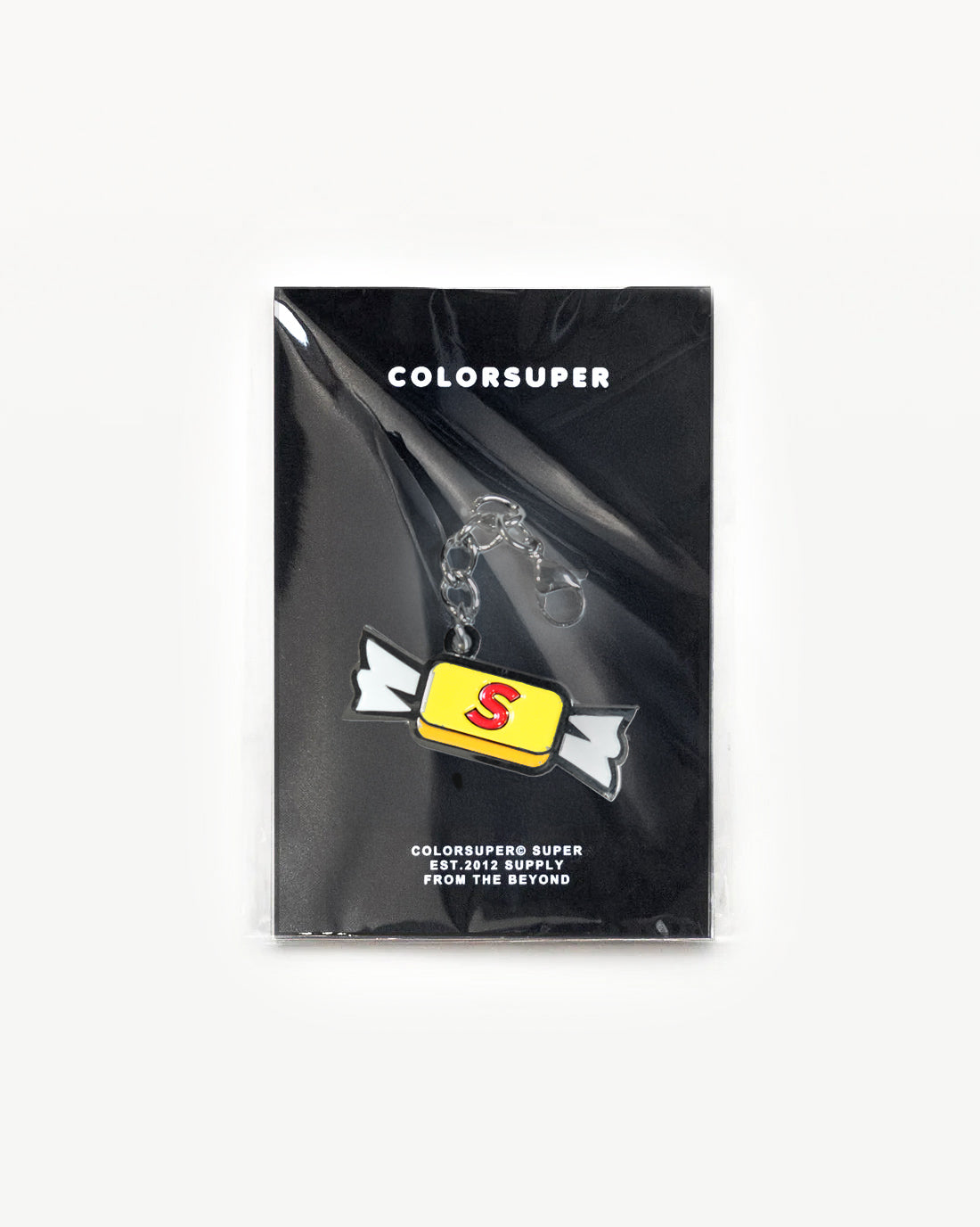 Bikini Charm in packaging, featuring a bright yellow candy design with the letter S, adding playful color to accessories.