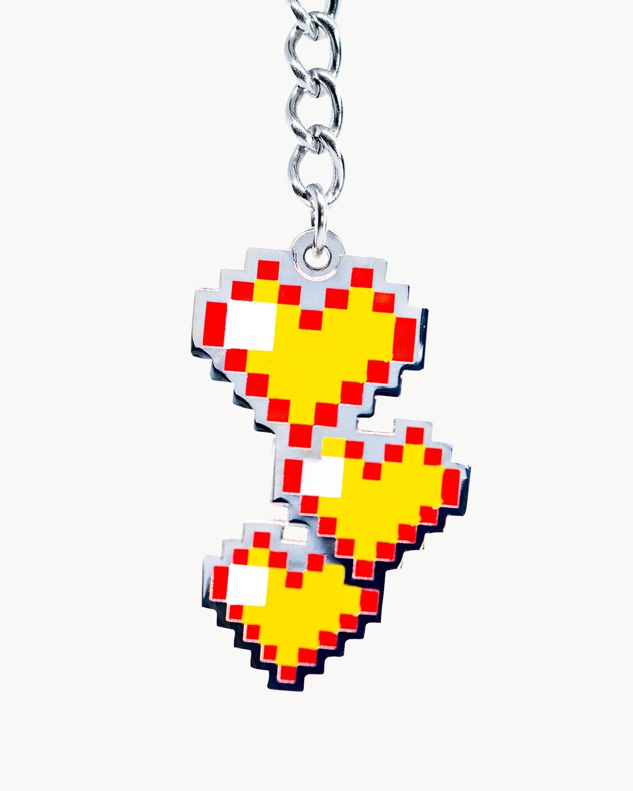 Bikini charm featuring pixelated yellow hearts, a fun accessory to elevate summer swimwear styles.