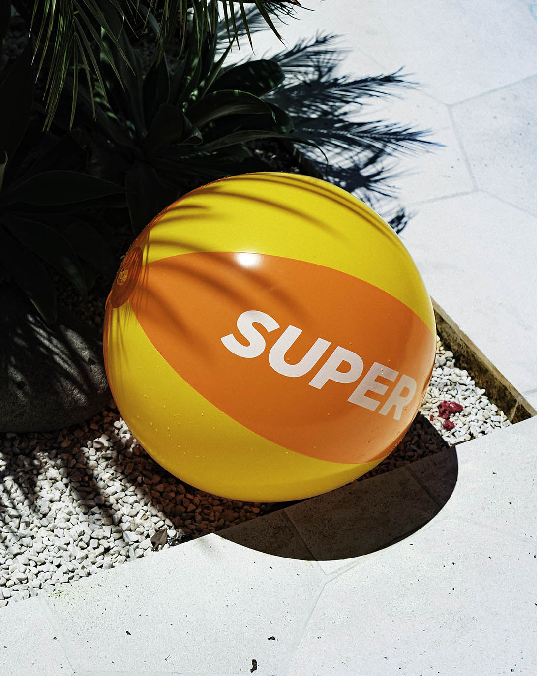 Beach ball with solid orange and yellow design.