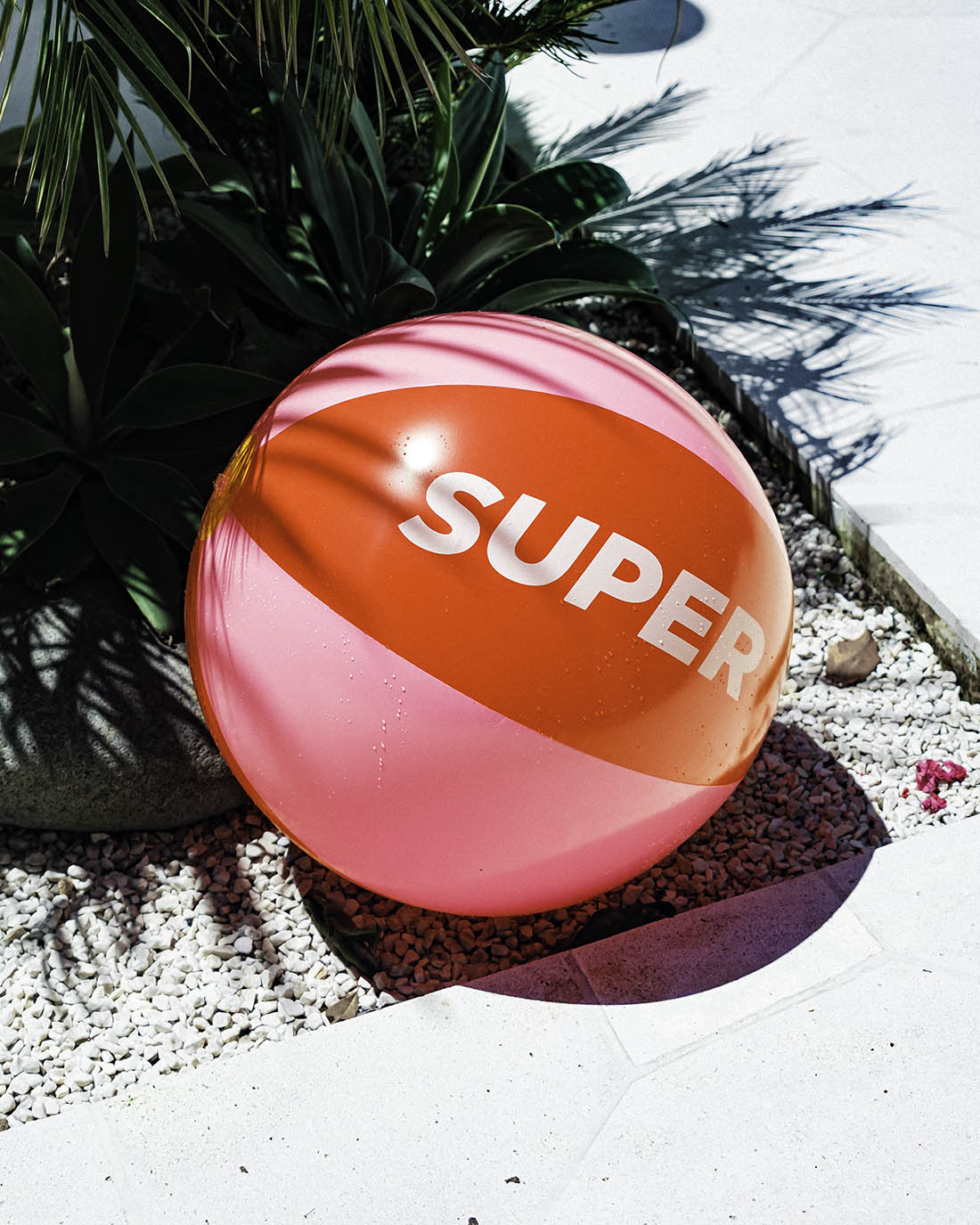 Beach ball with solid red and pink design.