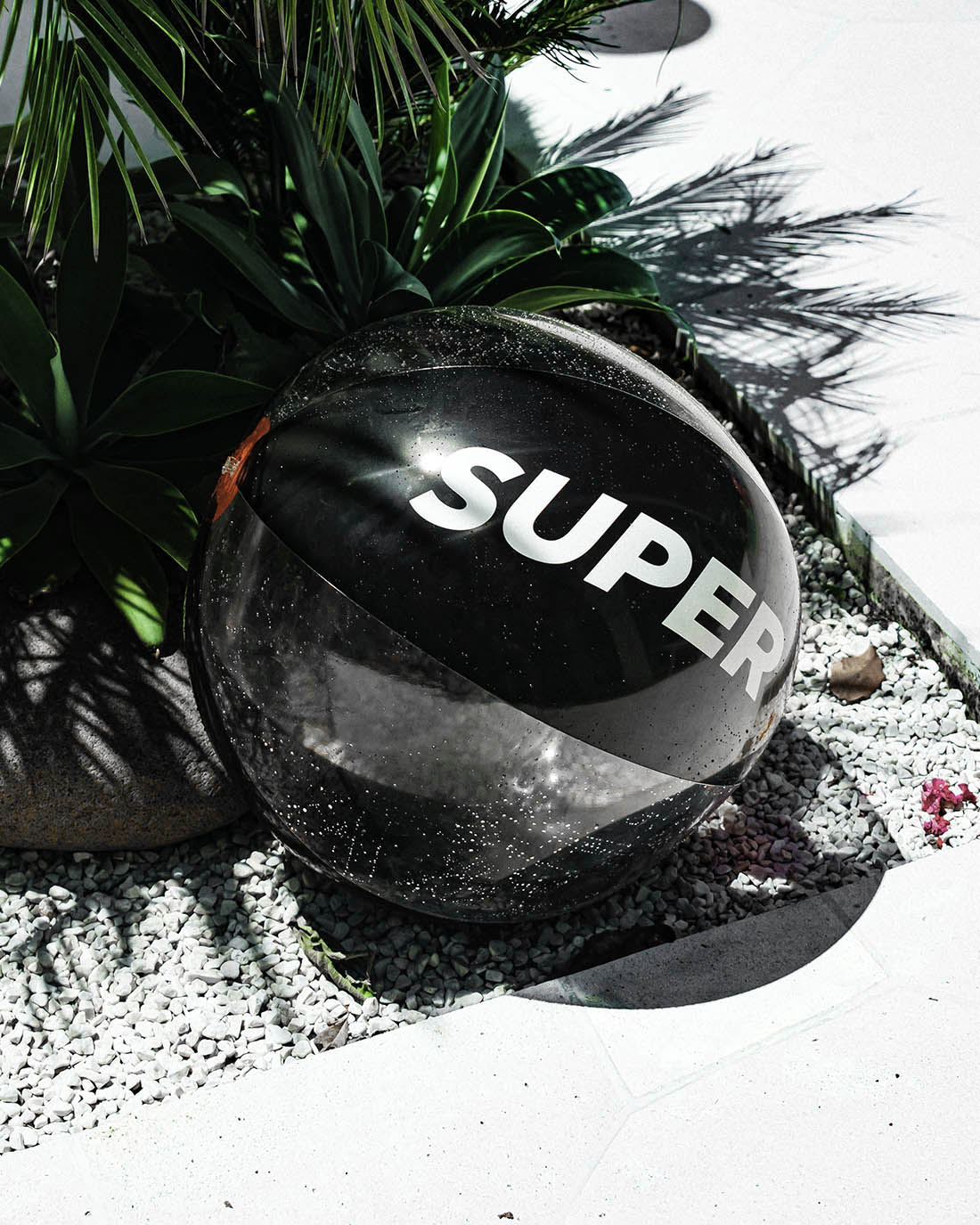 Beach ball with solid black and clear design.