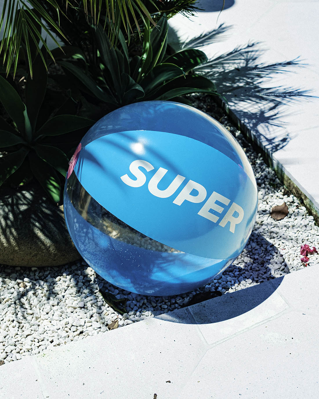 Beach ball with solid blue and clear design.